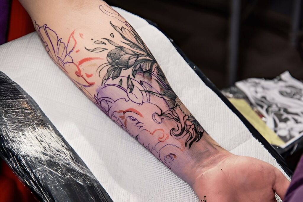 name cover up tattoo blended into sleeve