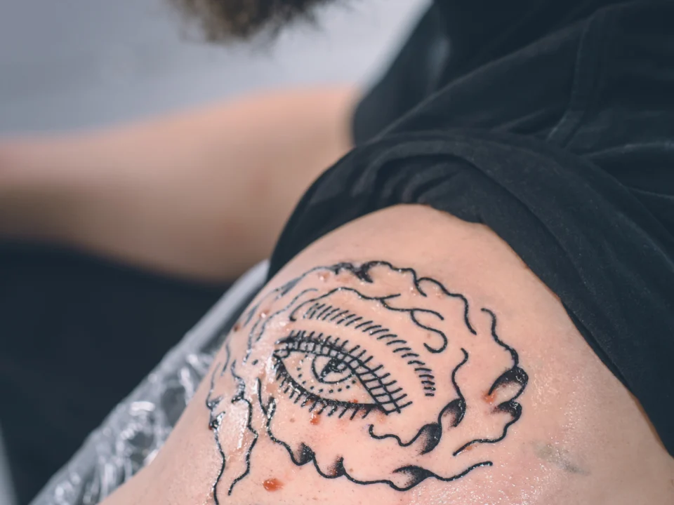 Smoke gap filler tattoo design creating soft background shading between bold tattoo pieces