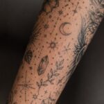 Tiny tattoo filler ideas with stars, sparkles, and dotwork fillers between patchwork sleeve tattoos